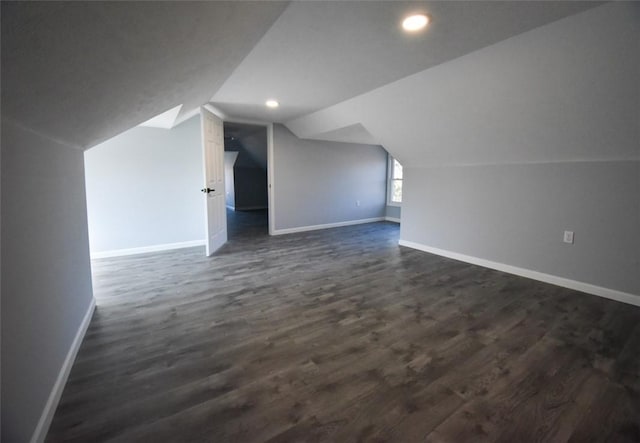 bonus room with dark wood finished floors, recessed lighting, baseboards, and vaulted ceiling