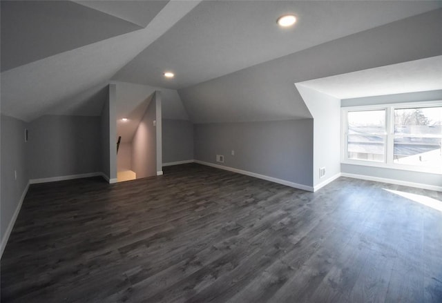 bonus room with visible vents, baseboards, dark wood finished floors, vaulted ceiling, and recessed lighting