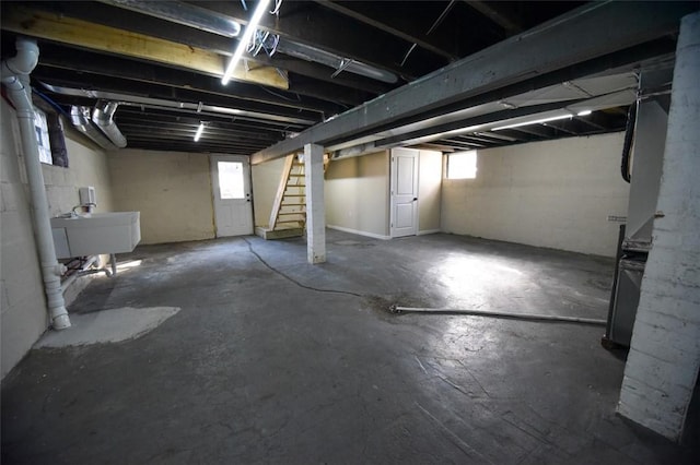 basement featuring a sink and stairway