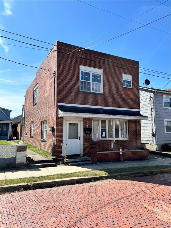 view of front of property featuring brick siding and entry steps