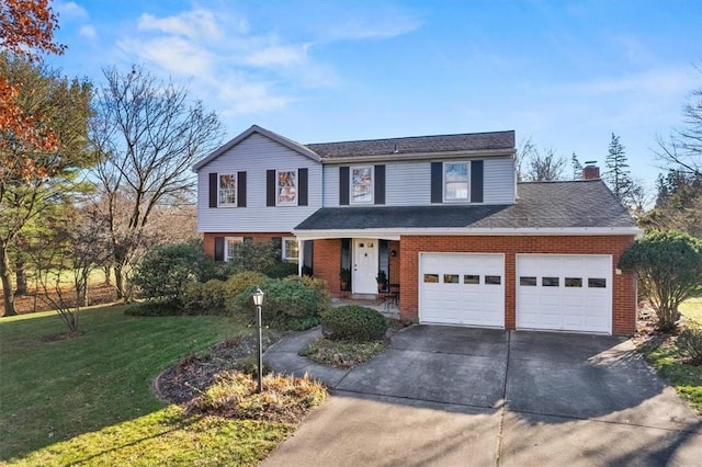 traditional-style home featuring a front yard, concrete driveway, brick siding, and an attached garage