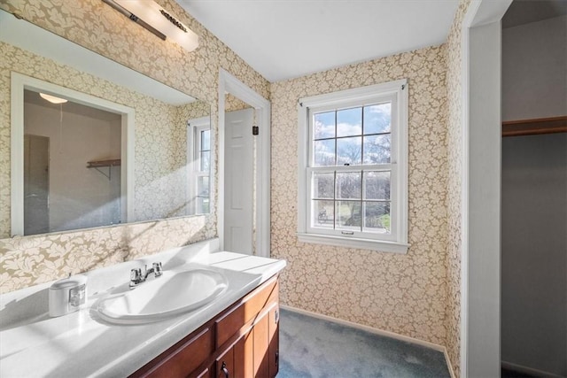 bathroom with wallpapered walls and vanity