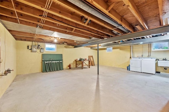 below grade area featuring a sink and washer and clothes dryer