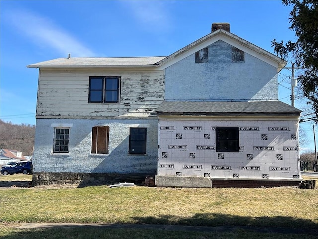 view of home's exterior featuring a yard and brick siding