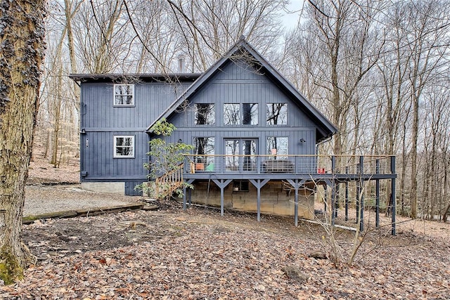 back of property featuring a wooden deck