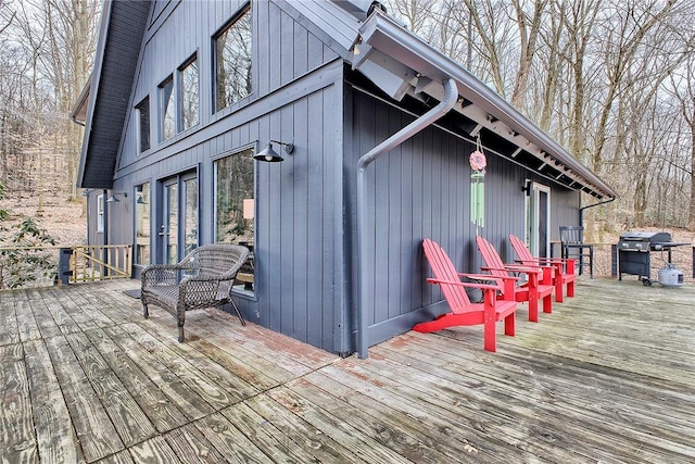 wooden deck with a grill