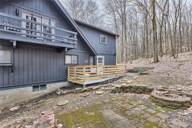 240 Birch Rd, Bullskin Twp, PA 15610 - rear view of house with a fire pit, a balcony, a deck, and a patio area