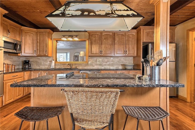 240 Birch Rd, Bullskin Twp, PA 15610 - kitchen with stainless steel microwave, exhaust hood, wood finished floors, wooden ceiling with exposed beams, and a breakfast bar