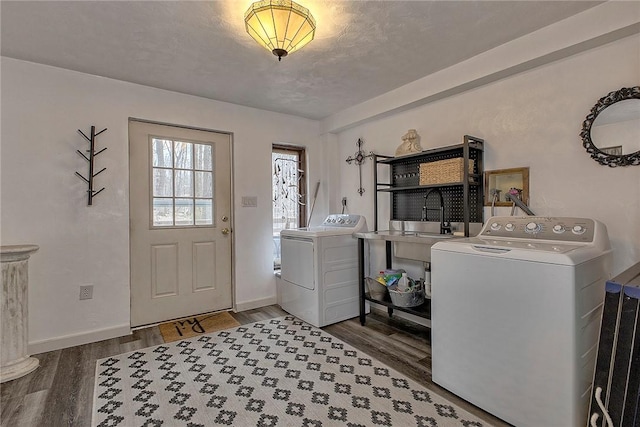 washroom with laundry area, independent washer and dryer, baseboards, and wood finished floors