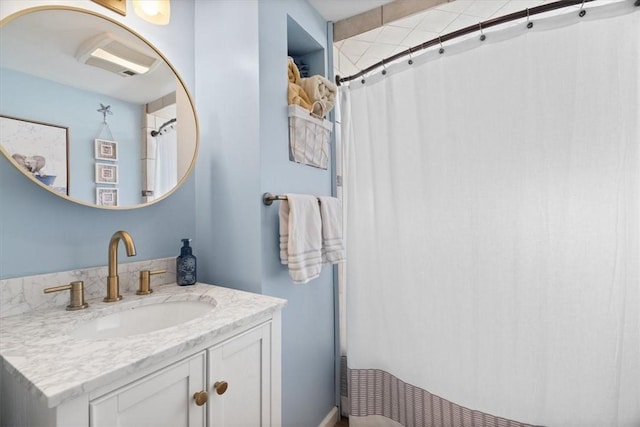 full bath featuring vanity and a shower with shower curtain