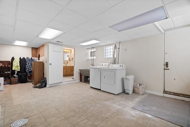 laundry room featuring laundry area, separate washer and dryer, and baseboards