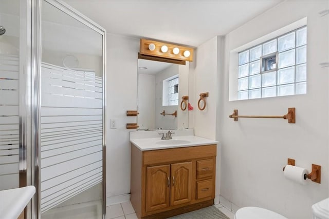 full bathroom featuring tile patterned flooring, a stall shower, toilet, and vanity