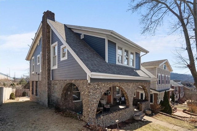 view of property exterior with fence, roof with shingles, and a chimney