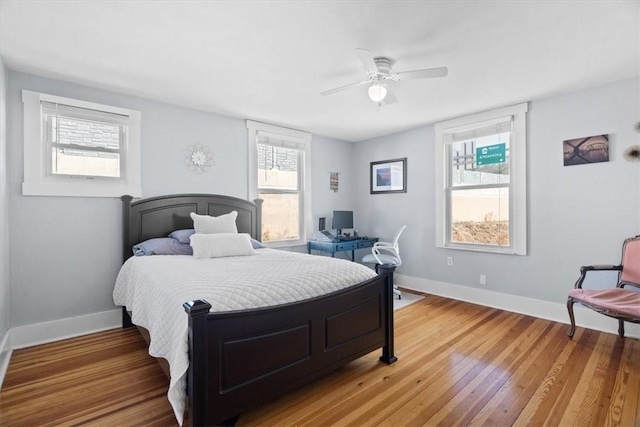 bedroom featuring ceiling fan, baseboards, and light wood-style flooring