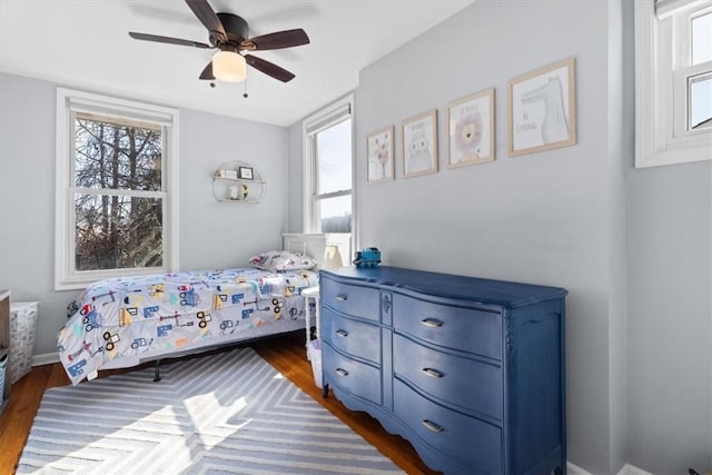 bedroom with dark wood-style flooring and ceiling fan