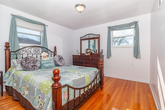 bedroom featuring baseboards and wood finished floors