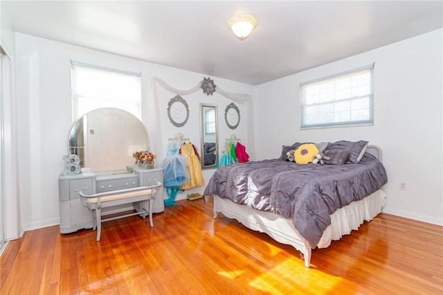 bedroom with baseboards and wood finished floors