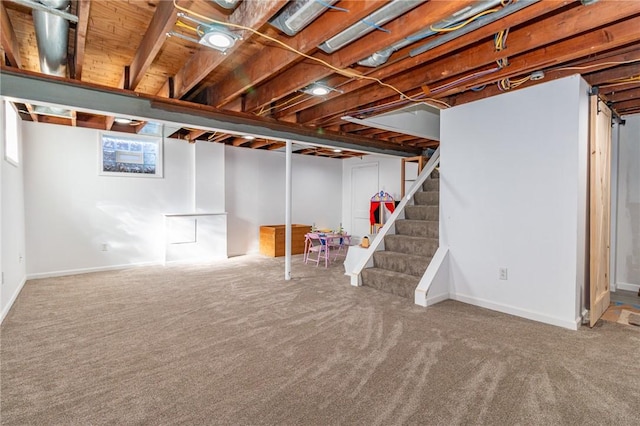 basement featuring stairway and carpet flooring