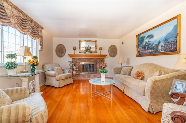 living area with wood finished floors and a fireplace