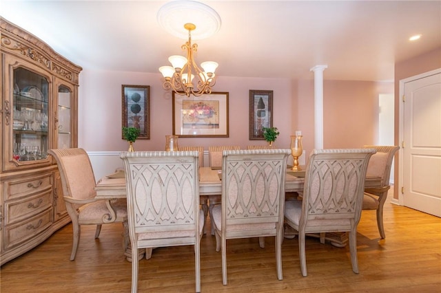 dining space with an inviting chandelier and light wood finished floors