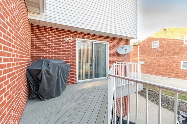 wooden terrace featuring area for grilling