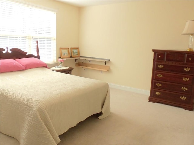 bedroom featuring baseboards and carpet floors