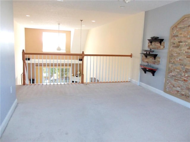 carpeted spare room featuring recessed lighting, baseboards, and plenty of natural light