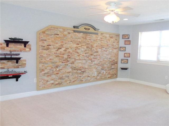 empty room featuring baseboards, carpet, and a ceiling fan