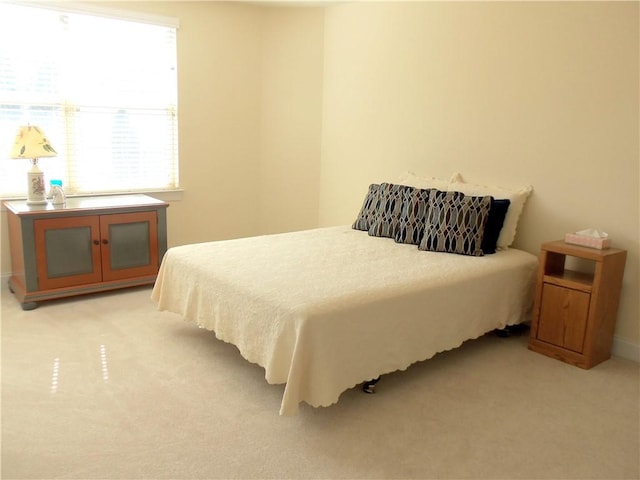 bedroom with light colored carpet