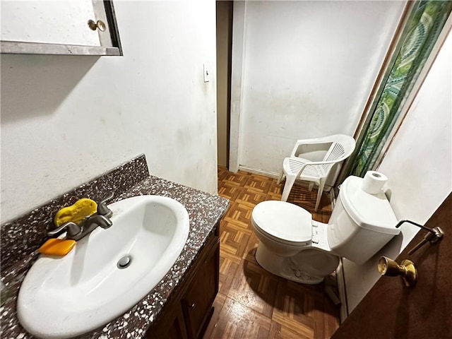 half bathroom with toilet and vanity