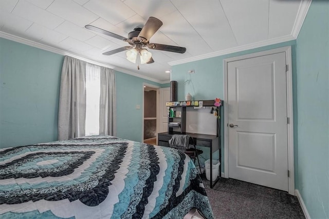 carpeted bedroom with crown molding, baseboards, and ceiling fan