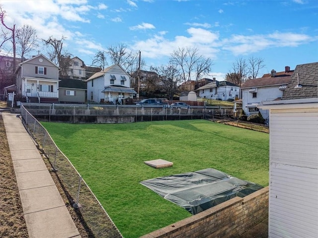 view of yard featuring a residential view and fence