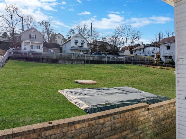 view of yard with a fenced backyard and a residential view