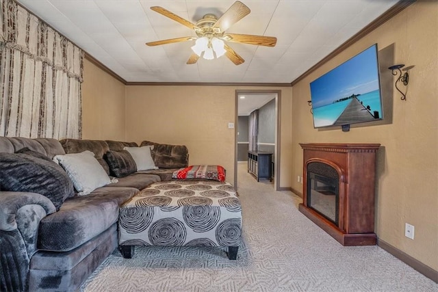 living room featuring baseboards, carpet floors, ceiling fan, and crown molding