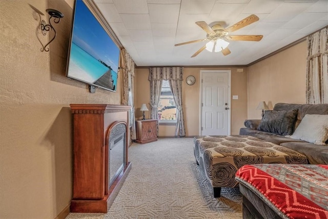 carpeted bedroom with baseboards, a ceiling fan, and ornamental molding