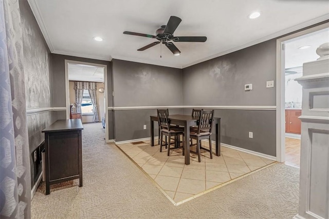 carpeted dining space featuring crown molding, recessed lighting, baseboards, and ceiling fan