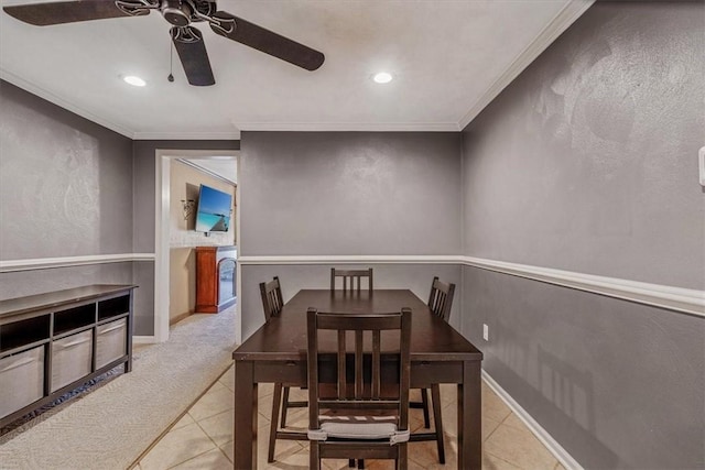 carpeted dining space with tile patterned flooring, baseboards, and ornamental molding