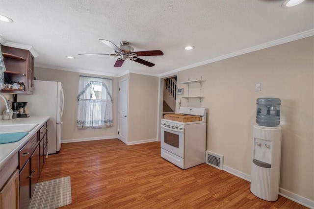 kitchen featuring white range with gas cooktop, light wood-type flooring, open shelves, and a sink