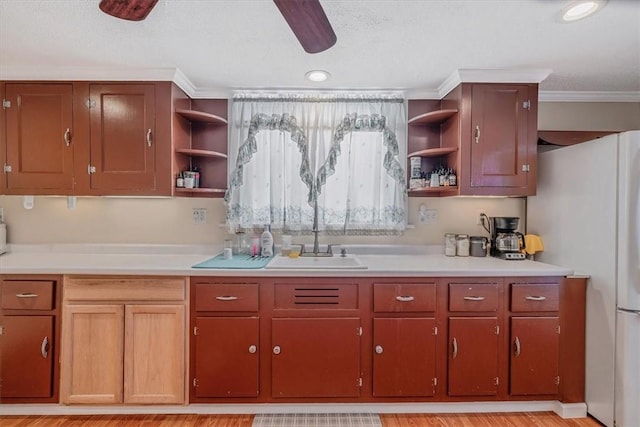 kitchen with open shelves, ceiling fan, light countertops, and freestanding refrigerator