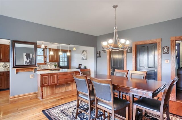 dining room with a chandelier and light wood-style floors