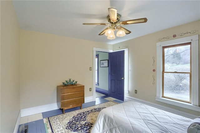 bedroom featuring a ceiling fan and baseboards