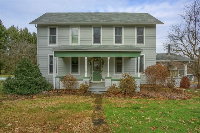 view of front of house with a porch and a front yard