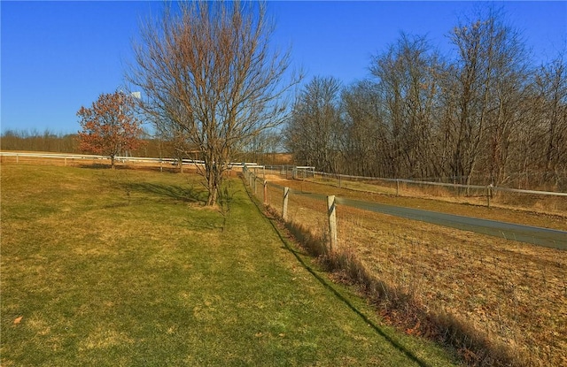 view of yard with a rural view and fence