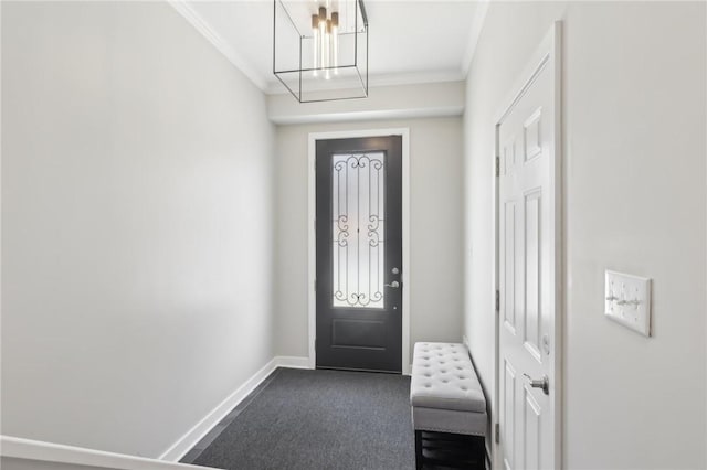 entryway with dark colored carpet, baseboards, and ornamental molding