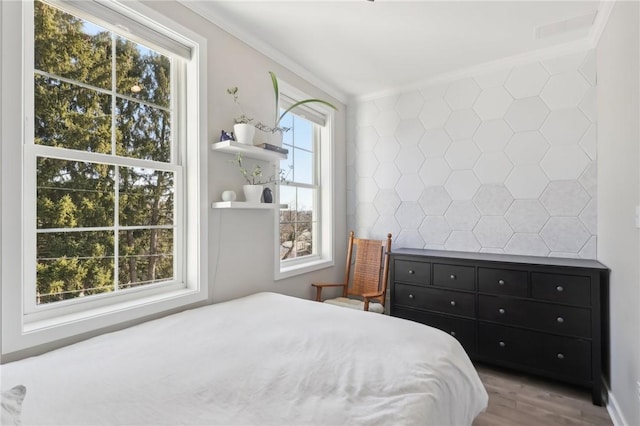 bedroom featuring crown molding and wood finished floors