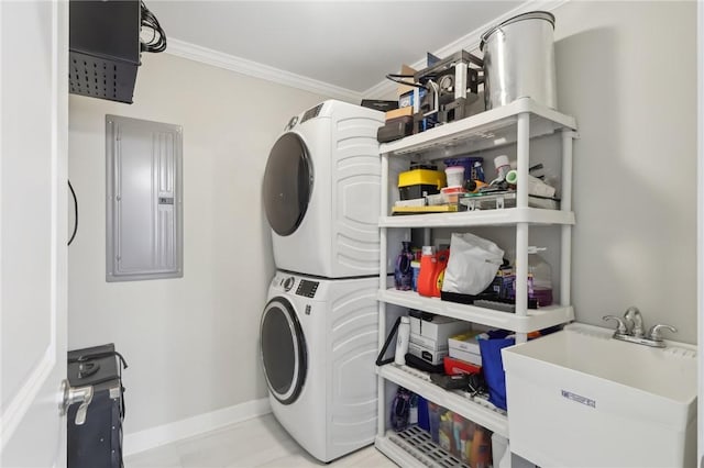 laundry area with a sink, electric panel, crown molding, stacked washer / dryer, and laundry area