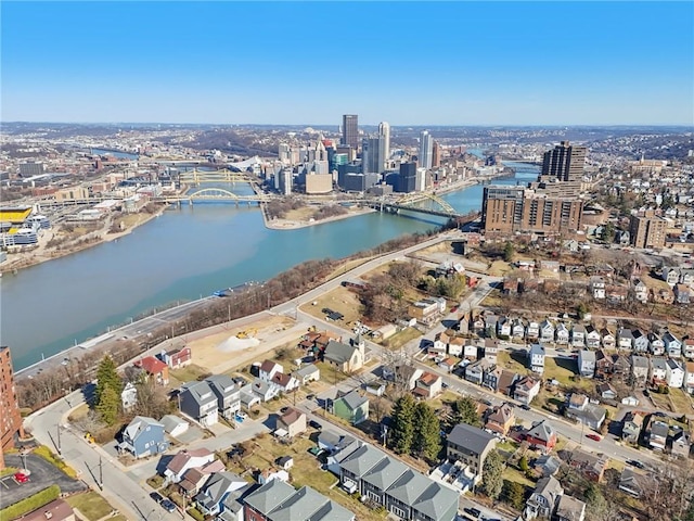 birds eye view of property with a view of city and a water view