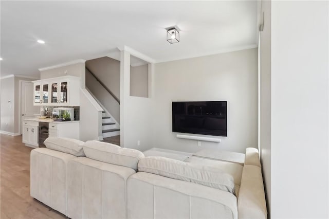 living room featuring light wood finished floors, crown molding, bar area, stairway, and recessed lighting