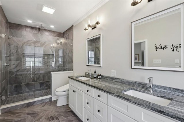 full bath featuring double vanity, toilet, a stall shower, and a sink