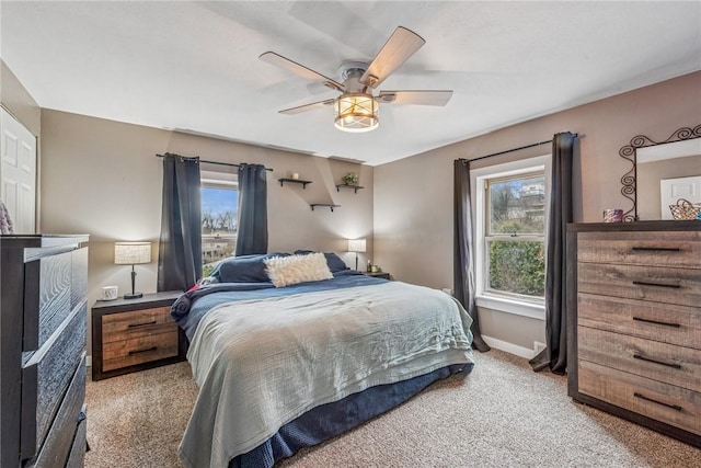 bedroom with baseboards, multiple windows, carpet, and ceiling fan